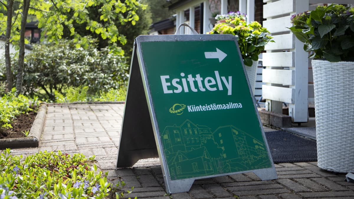 Kiinteistövälittäjän esittelykyltti asunnon edessä.