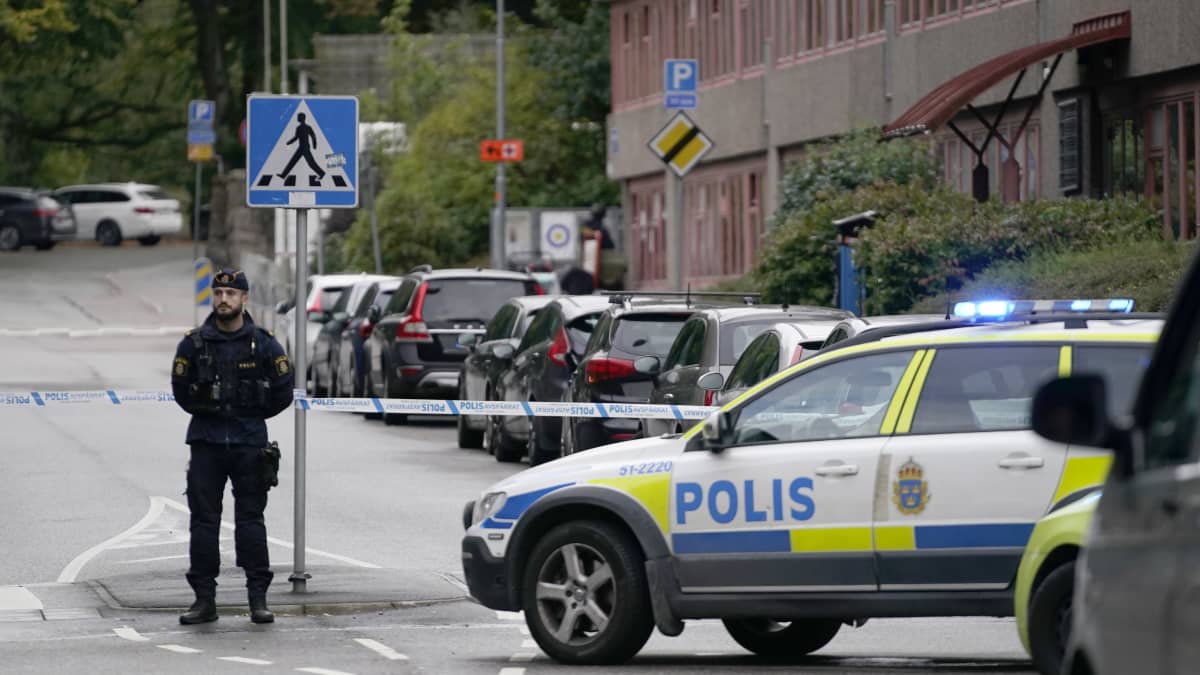 Poliisin teipillä eristämä alue ja sitä vartioiva poliisi Göteborgissa.