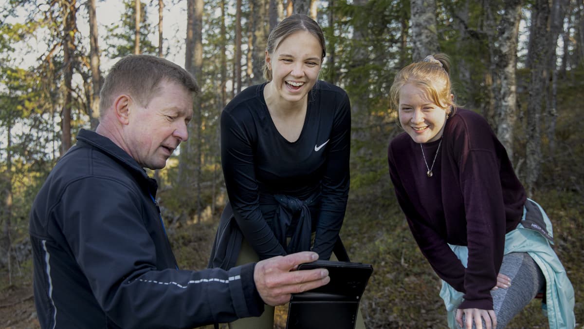 Pekka Väisänen näyttää Veera Auviselle ja Veera Tapanaiselle kuvaa kännykältään. 