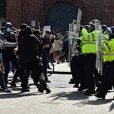 Poliisit ja mielenosoittajat kohtaavat kadulla Liverpoolissa. 