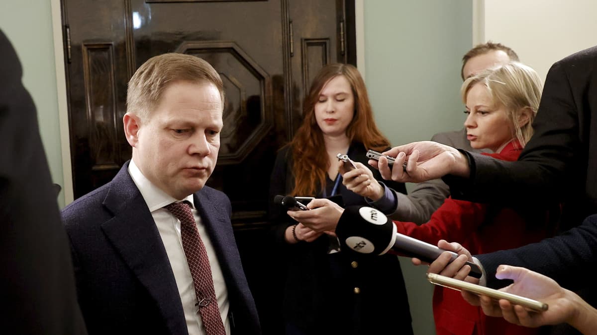 Social- och hälsovårdsutskottets ordförande Markus Lohi (C) är omgiven av journalister.