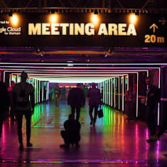 People walking in a lighted tunnel at the Slush start-up conference.