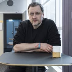 Venäläinen Jevgeni Goman nojaa pöytää vasten.