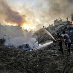 Palestiinalaiset sammuttavat tulipaloa Gaza Cityssä 25. lokakuuta 2023.
