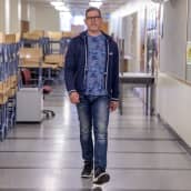 Rehtori Jouni Saarinen kävelee koulun käytävällä.
