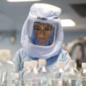 Suojapukuun pukeutunut yöntekijä testaa rokotevalmistuksen prosesseja Biontechin tehtaalla Saksan Marburgissa