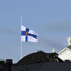 The Finnish state flag at half-mast over the Government Palace in Helsinki on 16 October.