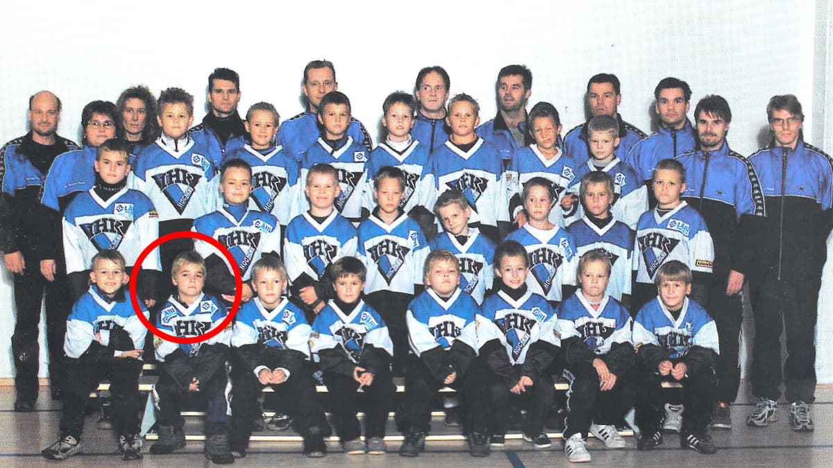 Jääkiekkojuniorit poseeraavat ryhmäpotretissa. 