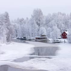 A boat in a wintry scene.