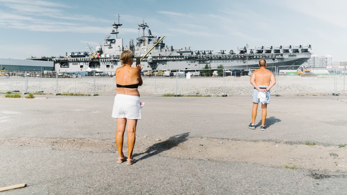 Ihmisiä katsomassa USS Kearsargea Hernesaaren rannassa.