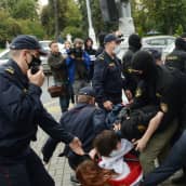 Valko-Venäjän poliisi ja OMON-erikoispoliisit taltuttavat opiskelijoita jotka osoittavat mieltä.