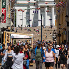 People on the street with Helsinki's Lutheran Cathedral in the background. 