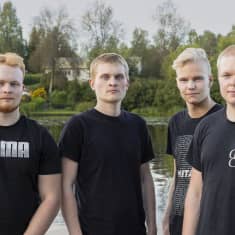 Seventine-yhtyeen jäsenet Vainö Kemppinen (kitara), Mika Kontinen (rummut), Paavo Auvinen (örinä ja kitara) ja Kim Miettinen (laulu ja basso). Miehet seisovat rannalla Sulkavalla. 