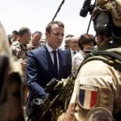  Emmanuel Macron keskustelee ranskalaisten sotilaiden kanssa Malin tukikohdassa.
