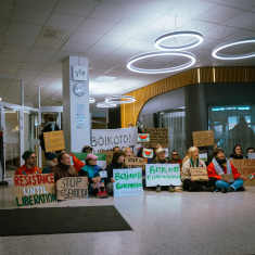 Protesters sitting in Yle's reception area.