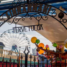 Entrance to Linnanmäki amusement park, with colourful rides visible in the background