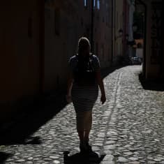 A woman walking down a cobbled street
