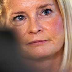 A closeup of Riikka Purra's face at a press event. 