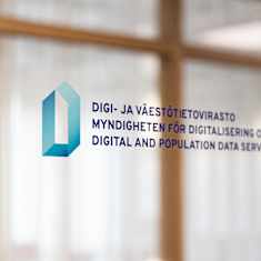 Logo of the Digital and Population Data Services Agency on glass in Finnish, Swedish and English.