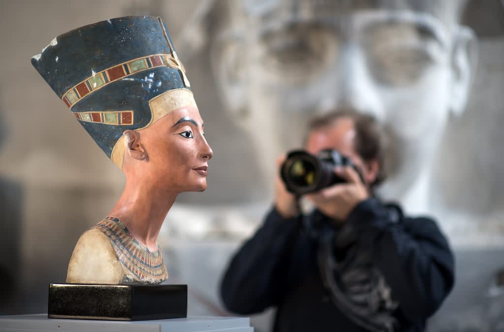 Valokuvaaja tähtää Nefertitin rintakuvan kopiota. 