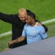 Manchester Cityn valmentaja Pep Guardiola neuvoo vaihtomies Raheem Sterlingiä.