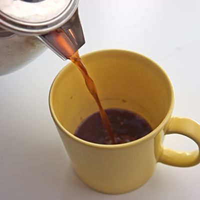 Coffee being pured into a cup.
