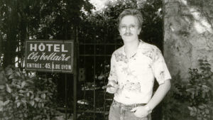 Kari Enqvist toimi CERNin teoriaosastolla. Siellä hän tuli temmatuksi tutkimuksen eturintamaan. Kari Enqvist hotellikyltin vieressä Lyonissa.