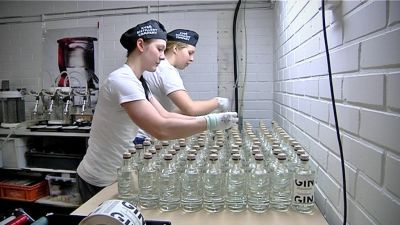Marianne Aheinen och Juulia Rinta sätter korkar på flaskorna.