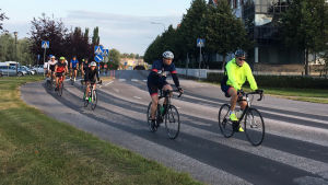 Regionchef Mikael Crawford i täten med gul rock. Bilden är från touren 2019. Starten gick klockan 7 från Krämaregatan i Borgå och här cyklar deltagarna längs Ågatan. En klunga cyklister i Borgå. Längst fram cyklar en man i svart och en man i gul jacka.