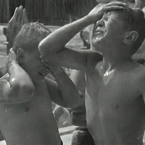 Pojat suihkun alla Kumpulan maauimalassa (1952).