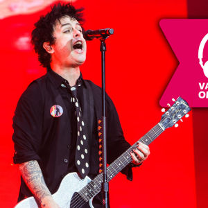 Billie Joe Armstrong från gruppen Green Day spelar gitarr på scen.