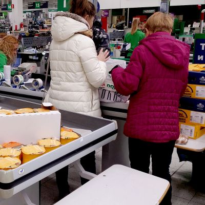 Venäläisiä ostamassa juustoa kaupan kassalla.