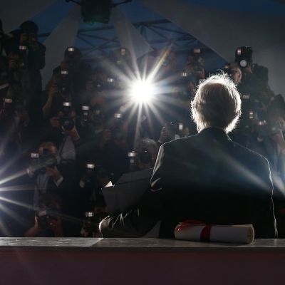 Kultaisella palmulla palkittu englantilaisohjaaja Ken Loach kuvattuna lehdistön ympäröimänä Cannesissa 22. toukokuuta 2016.