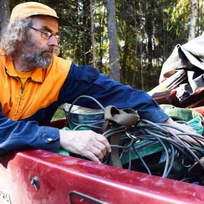 Aimo Särkijärvi kaivaa autonsa lavalta löytyvää työkalukasaa.