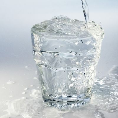 Vesilasi johon tulee vettä kraanasta.