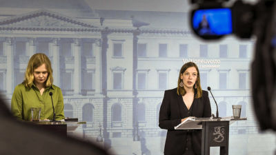 Hanna Kosonen och Li Andersson på en av statsrådets konferenser under pandemiåret 2020. De står vid varsin talstol och Li Andersson har ordet.