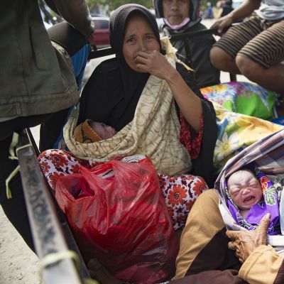 Nainen piti sylissään vastasyntynyttä lapsenlastaan Palussa, Indonesiassa 2. lokakuuta.