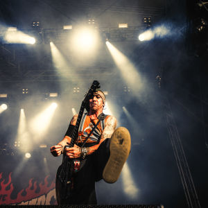Dregen in action. Dregen i The Hellacopters spelar gitarr och sparkar med foten framåt på Tuska 2019.