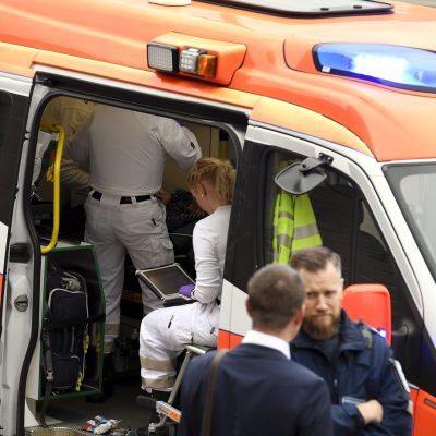 Poliiseja ja ambulanssi eduskunnan edustalla Helsingissä perjantaina.