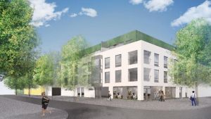 Såhär kan bostadshuset se ut. Ritning av ett ljust vitt flervåningshus som är omgärdat med träd.