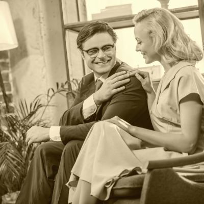 en ung man och en kvinna sitter på en soffa, svartvit bild