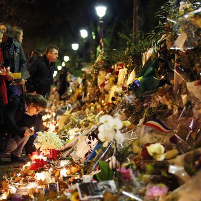 Ihmiset toivat kukkia ja kynttilöitä muistopaikalle lähelle Bataclan -konserttisalia, Pariisissa 20. marraskuuta.