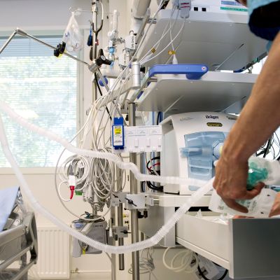 Sairaanhoitaja käsittelee hengityskonetta Meilahden tornisairaalassa,