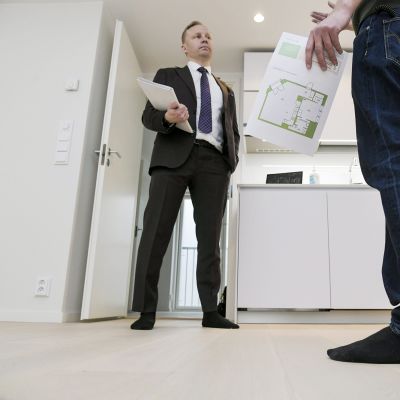 Kiinteistövälittäjä esittelee asuntoa.