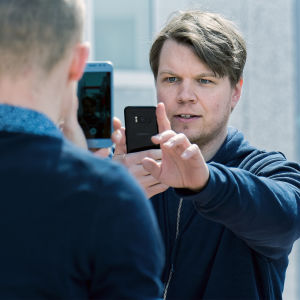 Lyhytelokuvan näyttelijä Hannes Suominen kuvaa kännykällä töistä miestä, joka on hänen edessään kuvaamassa kännykällä. 