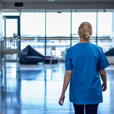 En sjukskötare går genom ett sjukhus.
