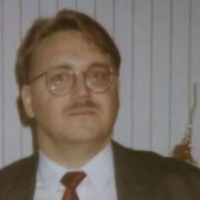 En man i mustasch och runda glasögon på en grynig gammal bild..
