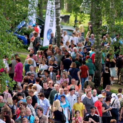 Ihmisiä tungeksi kapeilla käytävilllä puistossa.