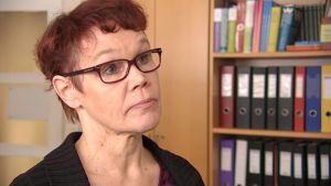 Merja Olkinuora är bildningschef i Ingå sedan 2015. Hon ansvarar för beredningen av ärenden i bildnings- och välfärdsnämnden. Arkivbild. Kvinna med glasögon står vid en bokhylla med mappar.