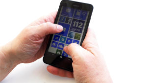 Hur många timmar om dagen stirrar du på din telefon? Någon som håller i en smarttelefon.